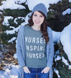 nurse in shirt about inspiration standing in the snow smiling